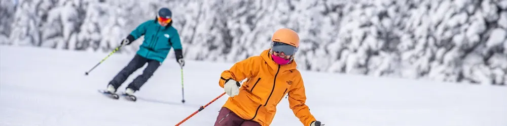 Two people skiing down Stratton Mountain